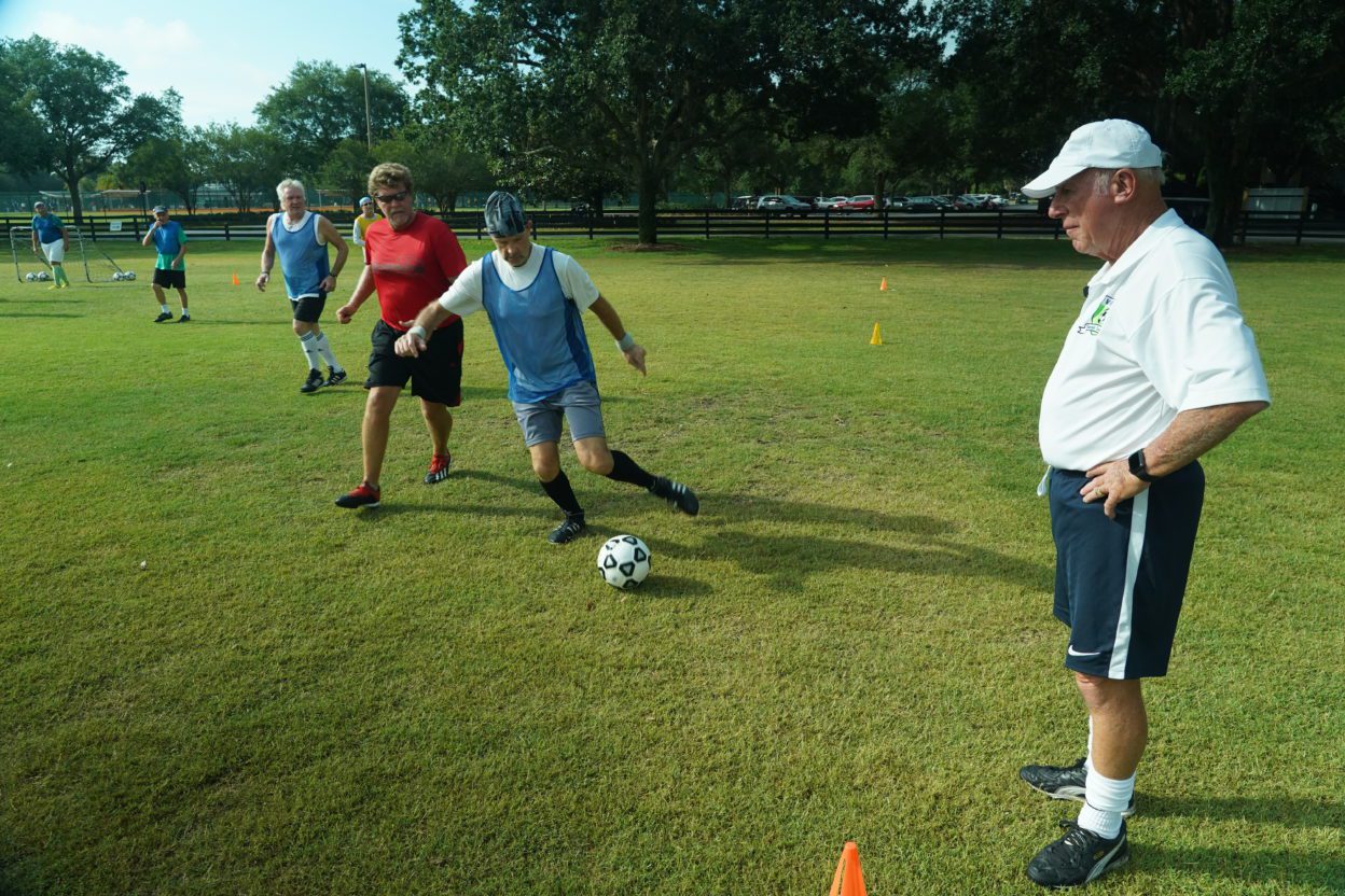 John Ellis, Head Coach of The Villages Senior Soccer Club, watches as players participate in drills