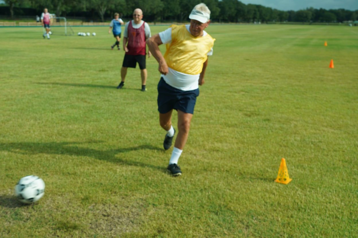 Alex Pringle, a participant at The Villages Senior Soccer Club, runs after the ball