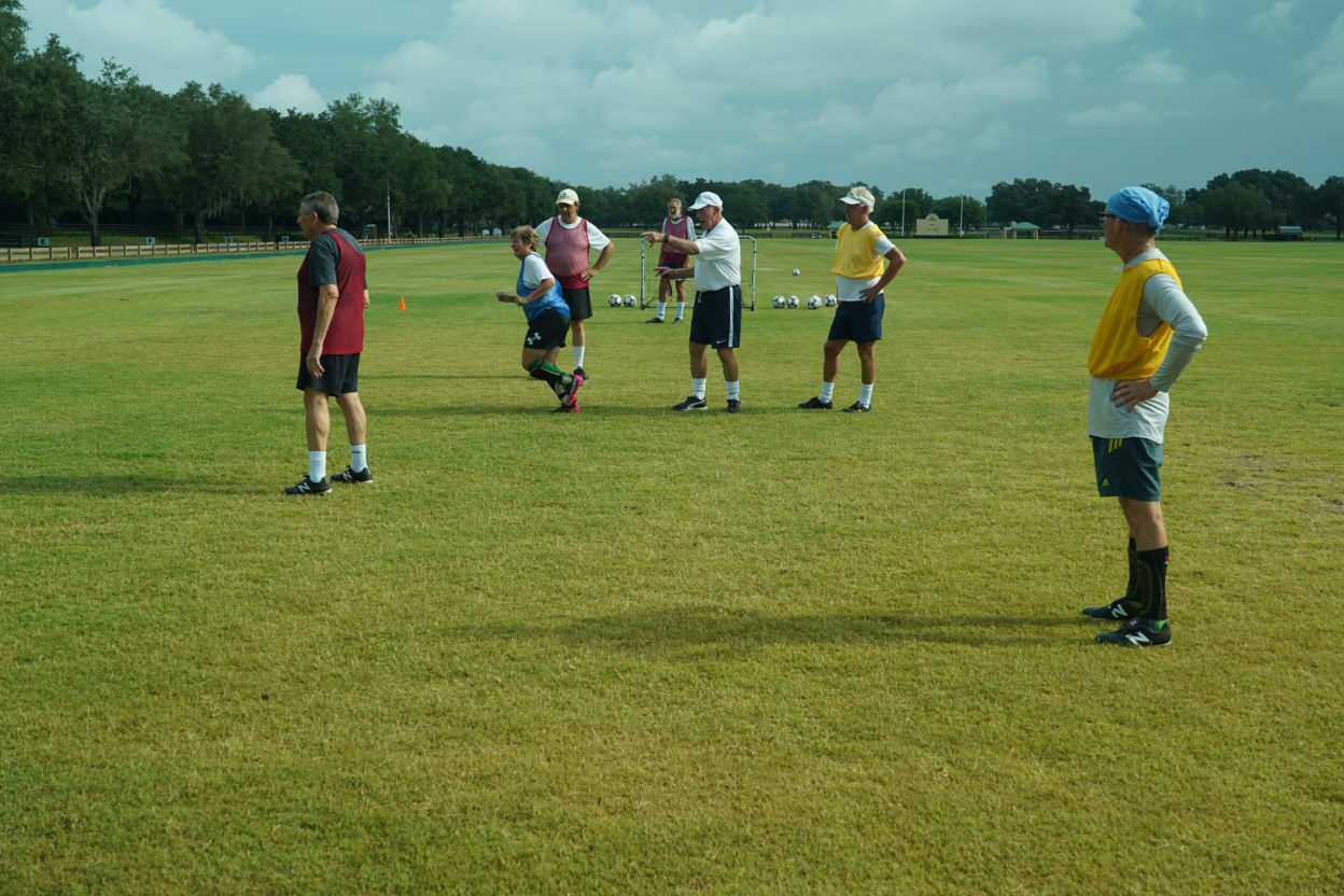 John Ellis, Head Coach of The Villages Senior Soccer Club, instructs his players
